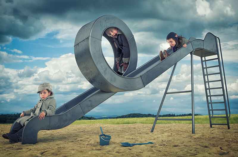 How does playing on slides help with child development?